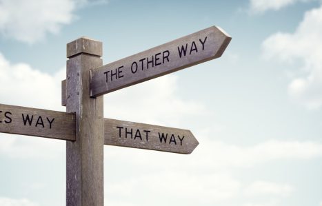 Crossroad signpost saying this way, that way, the other way concept for lost, confusion or decisions